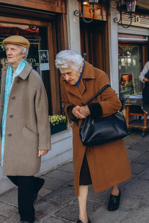 Rome, Italy-April 2, 2023:two retired women walking down a street in Rome.