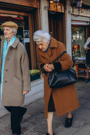Rome, Italy-April 2, 2023:two retired women walking down a street in Rome.