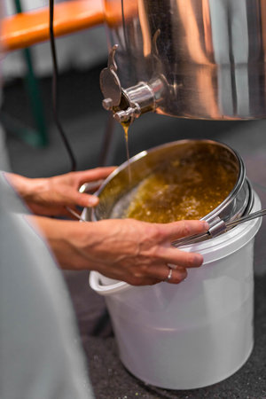 Machinery and equipment for beekeeping. Drip fresh honey into a bucketの写真素材