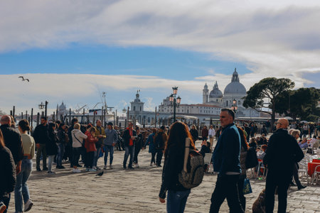 Venice, Italy - Italy 2, 2023: Crowds of tourists strolling on the cobblestone alley near Grand Canal in Venice.のeditorial素材