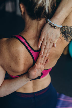 Attractive young woman practing yoga stretching yoga at home.