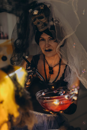 Cosmetologist in a Halloween costume at a beauty salon, festive atmosphere. High quality photoの写真素材