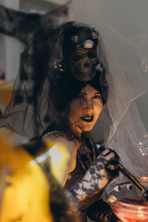Cosmetologist in a Halloween costume at a beauty salon, holding skincare tools, festive atmosphere. High quality photoの写真素材