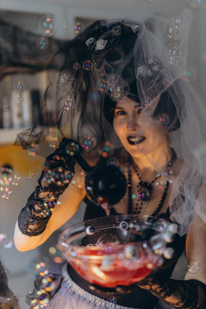 Cosmetologist in a Halloween costume at a beauty salon, festive atmosphere. High quality photoの写真素材