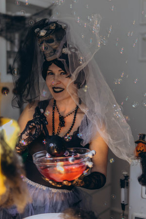 Cosmetologist in a Halloween costume at a beauty salon, holding skincare tools, festive atmosphere.の写真素材