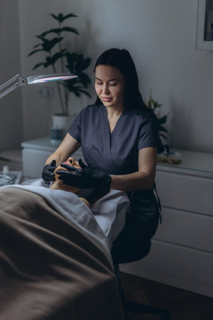 Middle aged woman receiving facial cleansing and care at a cosmetologist office. High quality photoの写真素材