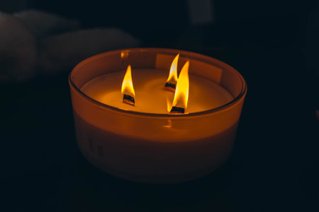 Three-wick candle symbolizing release and atmosphere of calm and serenityの写真素材
