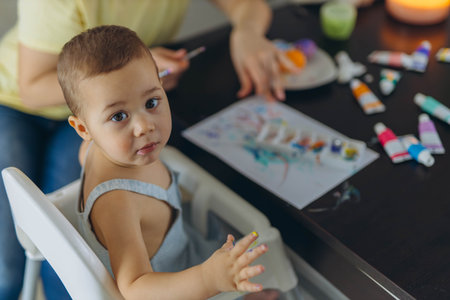 Little boy painting with his mother, enjoying creative moment together. Motherhood, parenting conceptの写真素材