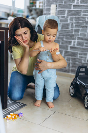 Angry mother scolding her son for breaking an egg in the kitchen. Parenting and discipline conceptの写真素材