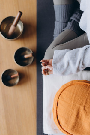 woman practicing yoga lesson with Tibetan Sound Bowl. Buddhism And Meditating Therapy. High quality photoの写真素材