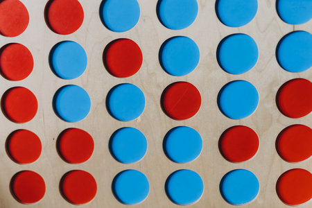 Wooden board with red and blue circles, creating a simple abstract composition with geometric shapes. High quality photoの写真素材
