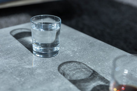 Close up of a glass of fresh water on a table in a living room. High quality photo