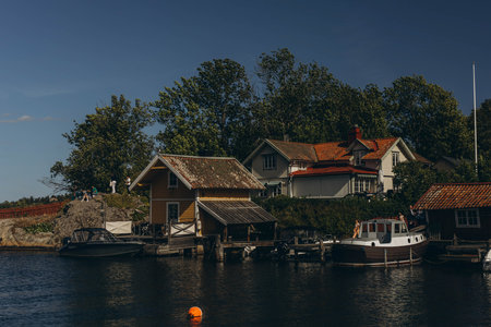 Small harbor with picturesque scandinavian wooden houses on a sunny day.Island of Vaxholm,Sweden....