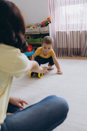 Mother and baby playing together with developmental toys, sitting in the floor, fostering learning. High quality photoの写真素材