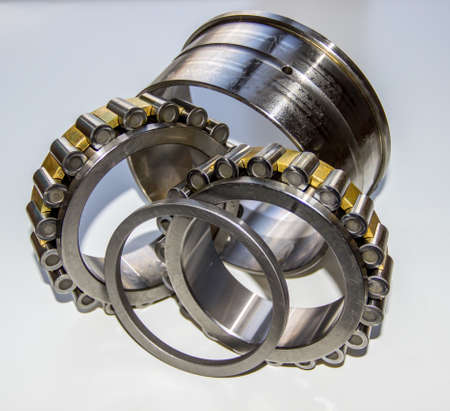 Exploded view of a double-row tapered roller bearing hub unit: a plane shaft washer, two roller...