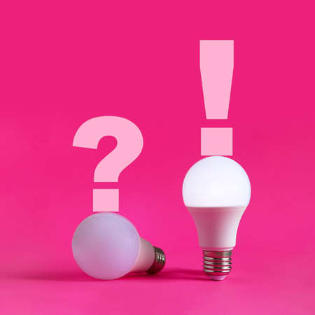 Two light bulbs, one of them glowing on pink background. Question and answer, problem and solution,...