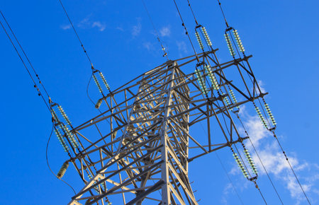 A power transmission line on a blue sky background. Perspective view