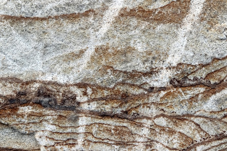 Texture of a colorful natural stone with layer structure as a backgroundの写真素材