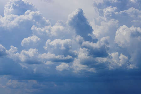 Blue sky with lowering clouds. Abstract darksome background