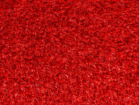 Red synthetic grass rug as a backgroundの写真素材