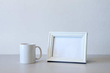 Mock up minimalist home interior with empty white wooden photo frame and ceramic mugの写真素材