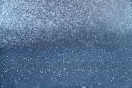 Sparkling blue glittery background for holiday, luxury, fashion designs. Photo in perspective with...