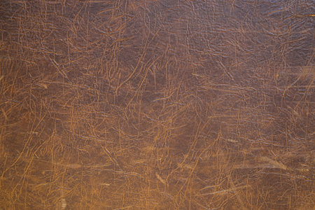 Texture of cracked brown leather as a vintage background