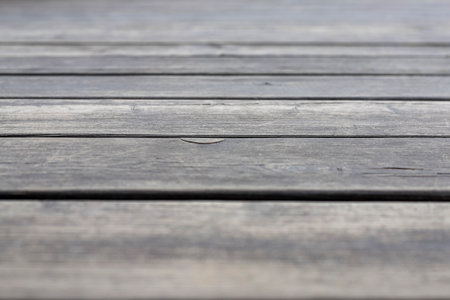 Closeup of an old wooden gray pavement as a background. Photo in perspective with selective focusの写真素材