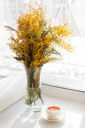 Pretty sunny morning tea and flowers. Morning summer or spring conceptの写真素材