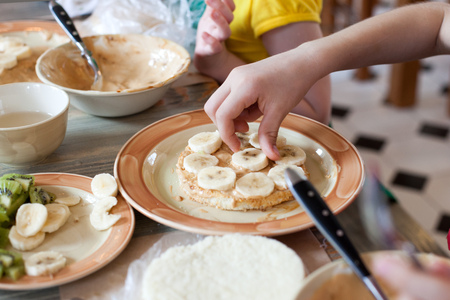 Cooking class, culinary. Food and people concept, child hands in process cooking of sweet cake.の写真素材