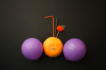 Concept of Halloween pumpkin orange cocktails on mystery black background. Festive drink, minimal trendの写真素材