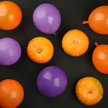 holidays, decoration and party concept - pumpkins, air balloons for halloween over black backgroundの写真素材