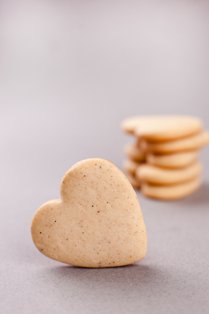 cookies in the shape of heart on a gray background, minimalism, concept of cooking, baking, symbol of loveの写真素材