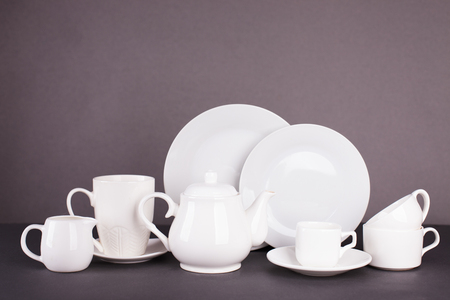 set of white utensils for lunch and tea party on a gray backgroundの写真素材