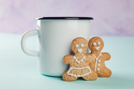 gingerbread man and woman stands near a white mug, family, love conceptの写真素材