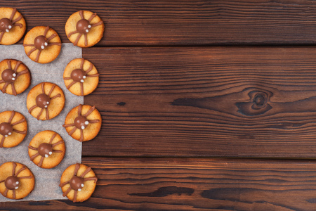 Halloween cookies with funny decorations on wooden kitchen table, copy spaceの写真素材
