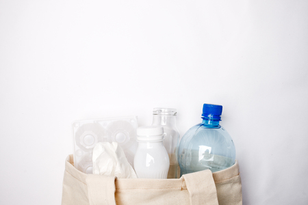 Composition with eco tissyue bag, paper, used box for eggs, packages, plastic, glass, prepared for recycling. Reduce, Reuse and Recycle concept. Flat lay, view from above, copy spaceの写真素材