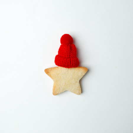 Christmas New Year Celebration Decorations Concept, ginger bread star with decorative red hat on whiteの写真素材