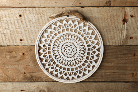 Macrame, mandala, dream catcher, shabby chic, copy space. Wedding or relaix time background. Crocheting mandala on vintage wooden backgroundの写真素材