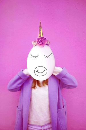 Girl with space instead of a face and egg head with unicorn decoration. Contemporary art collage.の写真素材