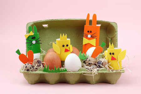 Easter holiday concept with eggs, cute handmade bunny, chicks in paper box for egg, springtimeの写真素材