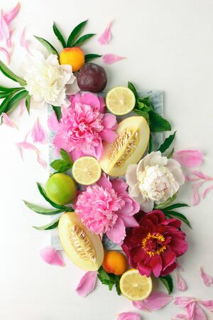 Creative layout made of various citrus fruits, plants, leaves and flowers decoration. Colorful Summer food and health concept. Flat lay, top viewの写真素材