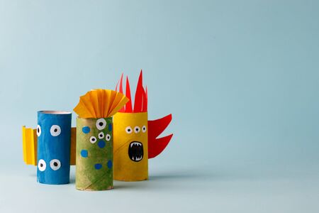 paper toy ghost, bat, monsters for Halloween party. Easy crafts for kids on blue background, copy...