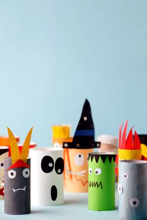 Halloween crafts, paper ghost, monsters on blue paper background with copy space for text. halloween concept handcraft, diy, creative idea from toilet tube, recycleの写真素材