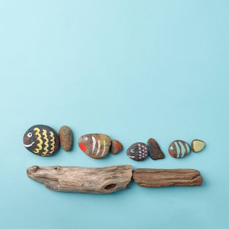 Happy family concept - drawing stone fish on blue background, Creative DIY kids idea, kindergarten, daycare imagination skill gamesの写真素材