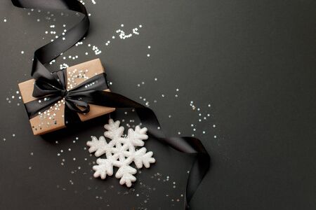 Beautiful christmas black silver decorative toys star snowflakes on dark blackの写真素材