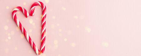 Heart shape Christmas candy on pink background with copy space, seasonal love minimal concept,...
