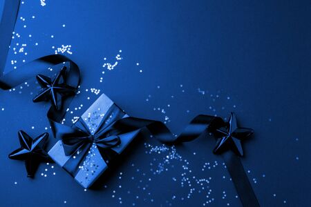 Christmas minimalistic and simple composition in mat trendy blue color. Christmas gift, toys...