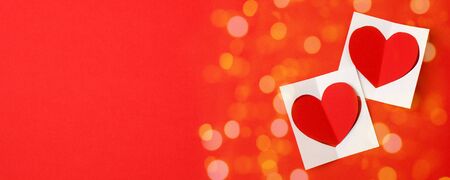 Two paper hearts on a red background. Empty place for copy space for text. mock-up, minimal concept...