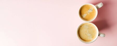 Couple white cups with coffee on pink pastel background, 8 march celebration minimal concept. Copy...